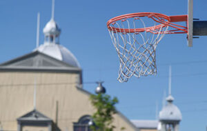 Image of a basketball net  with the Aberdeen Pavilion in the background