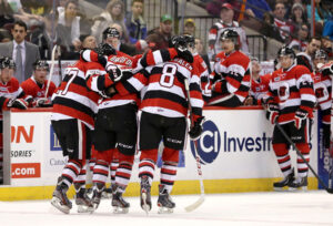 Image of 67's players helping an injured player off the ice