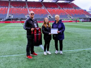 Image of fans on the field receiving an award before the Fury match