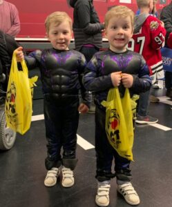 Image of 2 young 67's fans dressed in the Halloween costumes