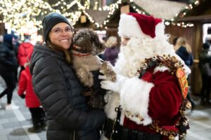 Image of a woman with her dog talking with Santa Claus at the Ottawa Christmas Market
