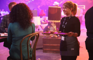 Image of a server serving canapés during a party in the arena at TD place