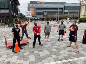 Image of REDBLACKS players, staff and Big Joe posing for a socially distant photo