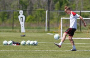 Image of an Atlético Ottawa FC players kicking a soccer ball