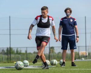 Image of an Atlético Ottawa FC players kicking a soccer ball