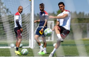 Image of an Atlético Ottawa FC players kicking a soccer ball