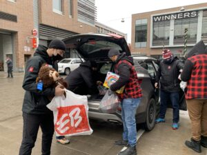 Image of 67's players and staff working at the holiday toy drive at TD Place